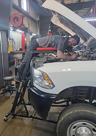 Tom's Auto Center - Shannon Shannon J. Works on a Vehicle at Tom’s Auto Center